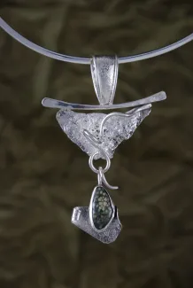 Silver and dinosaur bone pendant