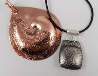 textured copper and silver hollow form pendants