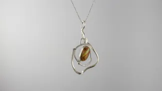 Silver pendant with brown and blue stone
