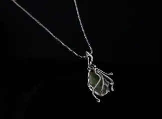 Silver pendant with green glass