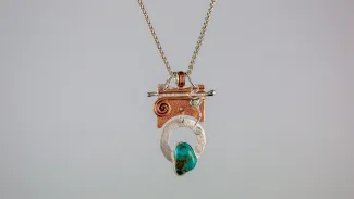 Silver and copper pendant with turquoise stone