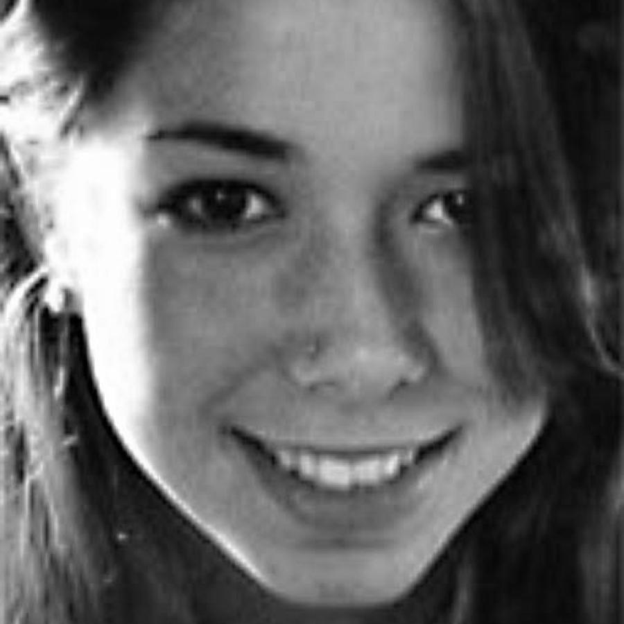 Close-up photograph of a smiling young woman with dark hair.