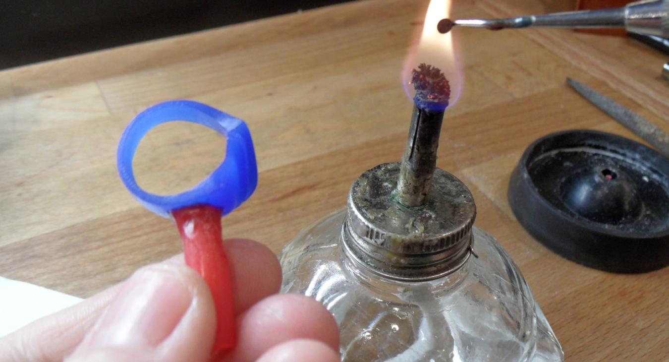 Attaching sprue wax to a ring before casting