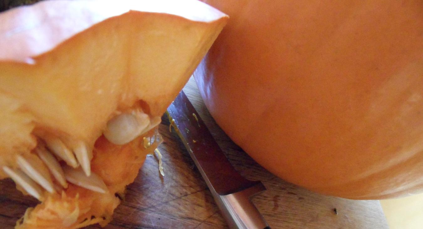 Knife next to pumpkins starting to be carved