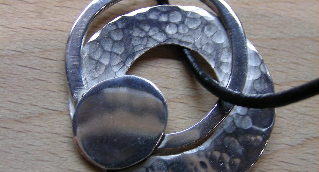 Multi-layered circular silver pendant