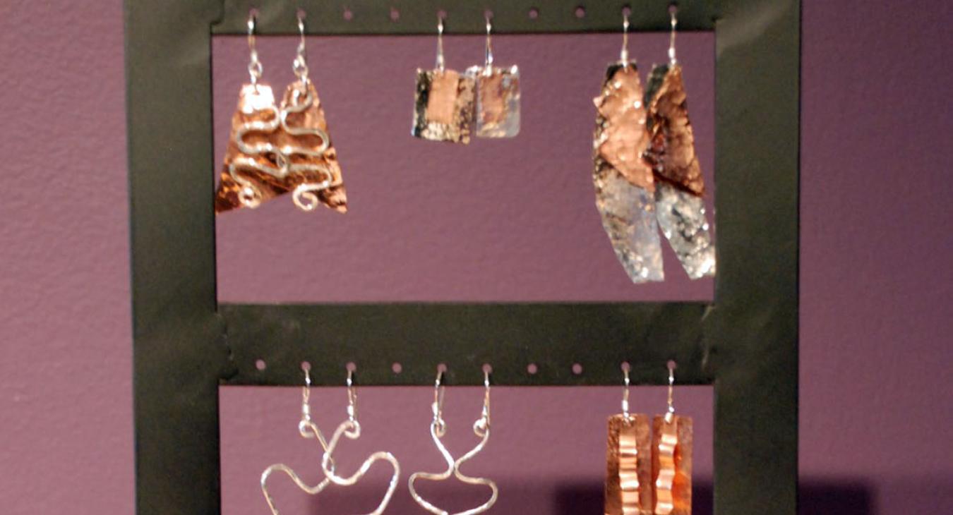 A display of silver and copper earrings