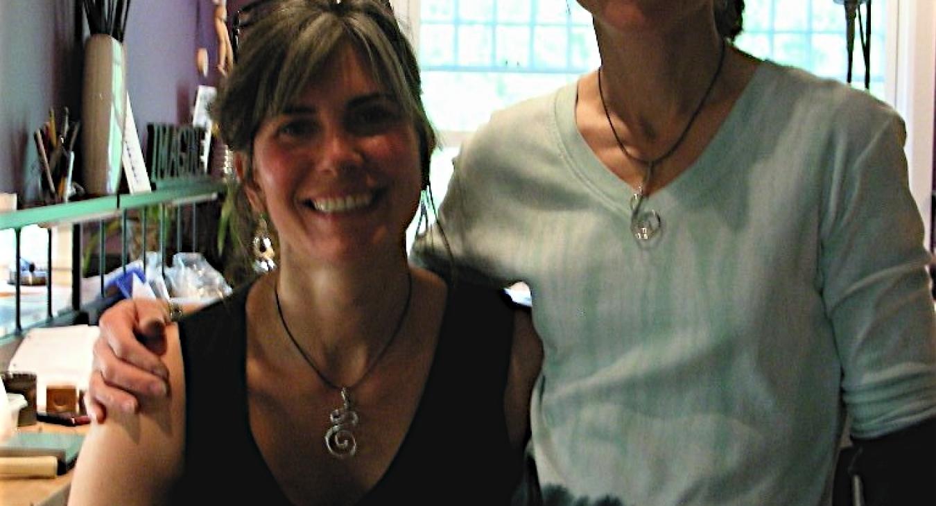 Samantha and Sarena wearing their swirl wire pendants