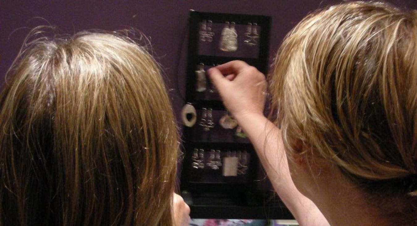 Student looking at silver earrings display