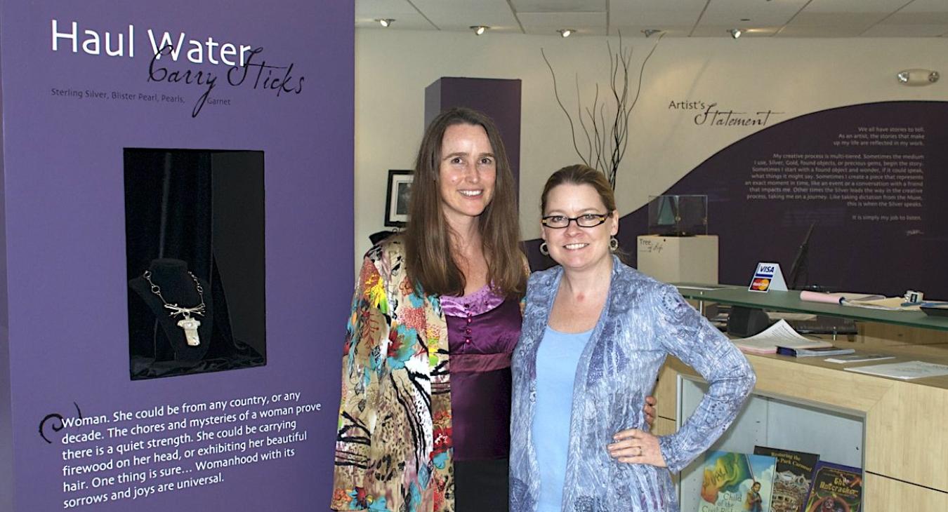 Blair and Megan in front of a tower display