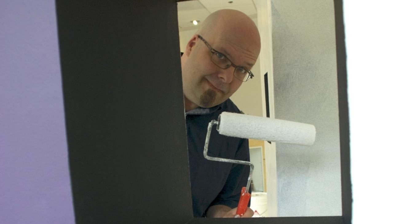 Bryan peeking through one of the towers with a paint roller