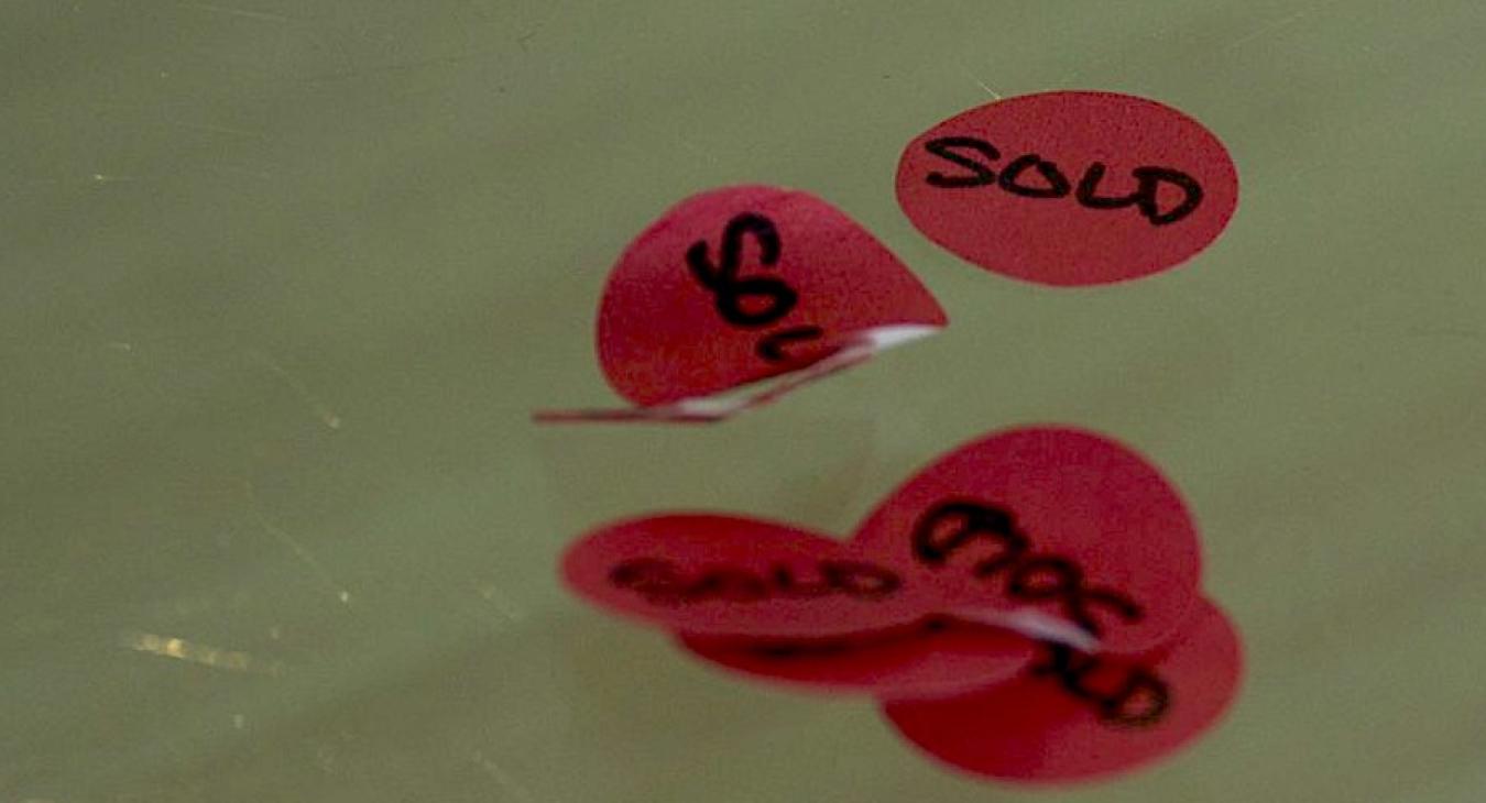 Red stickers that say "sold"