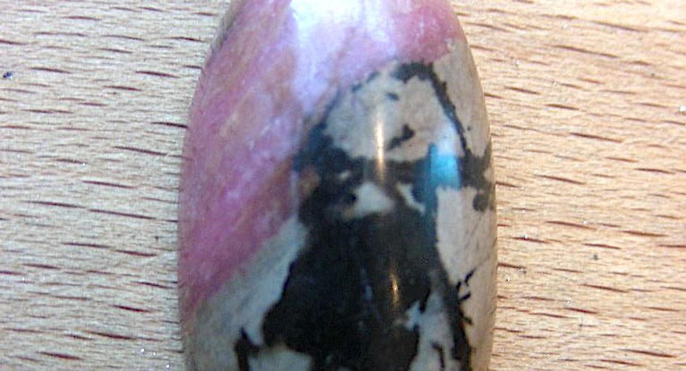 Pink brown and black rhodonite oval cabochon