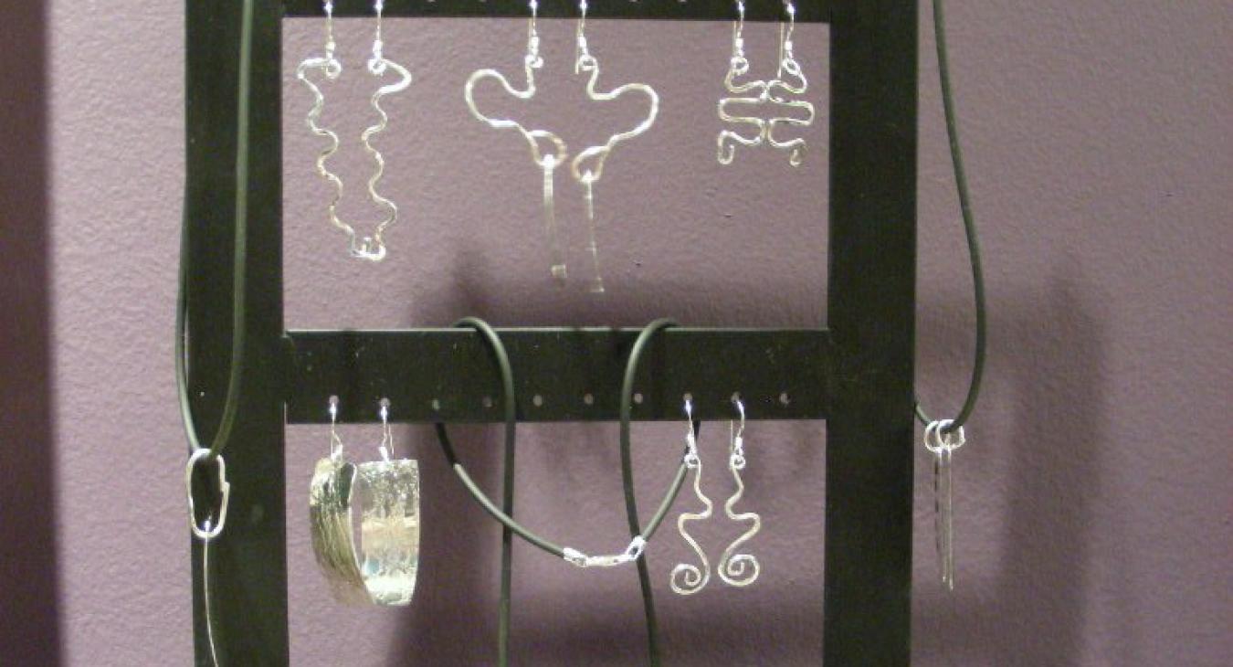 Silver earrings on a rack