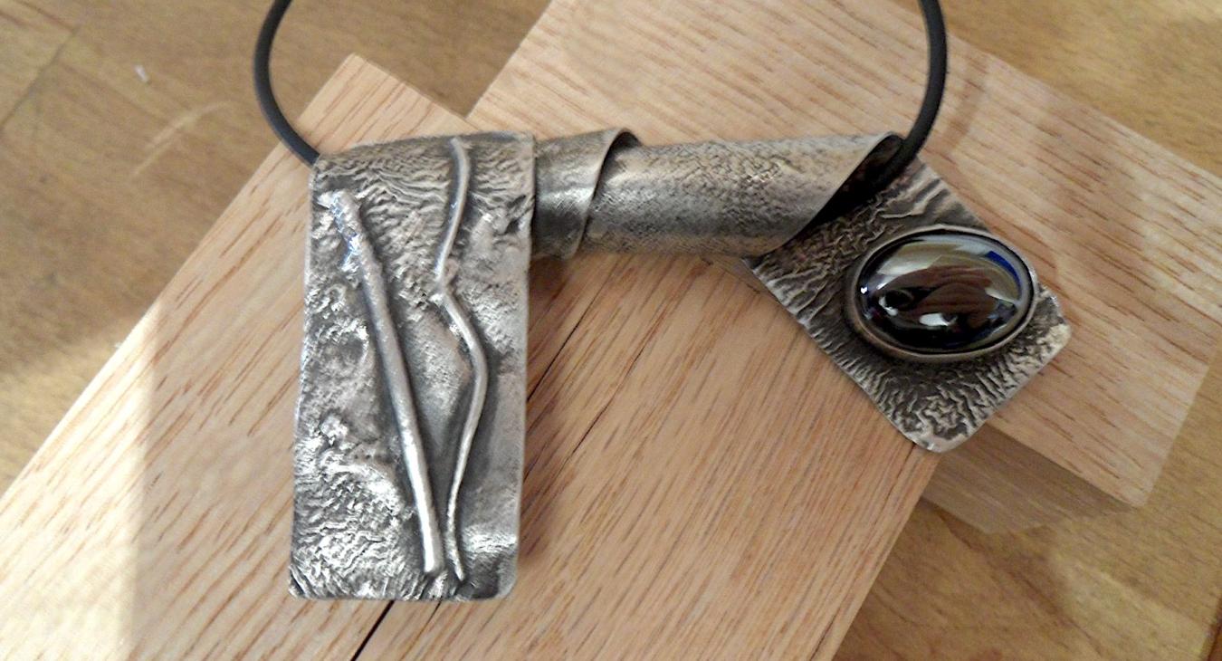 Folded reticulation silver pendant with brown stone