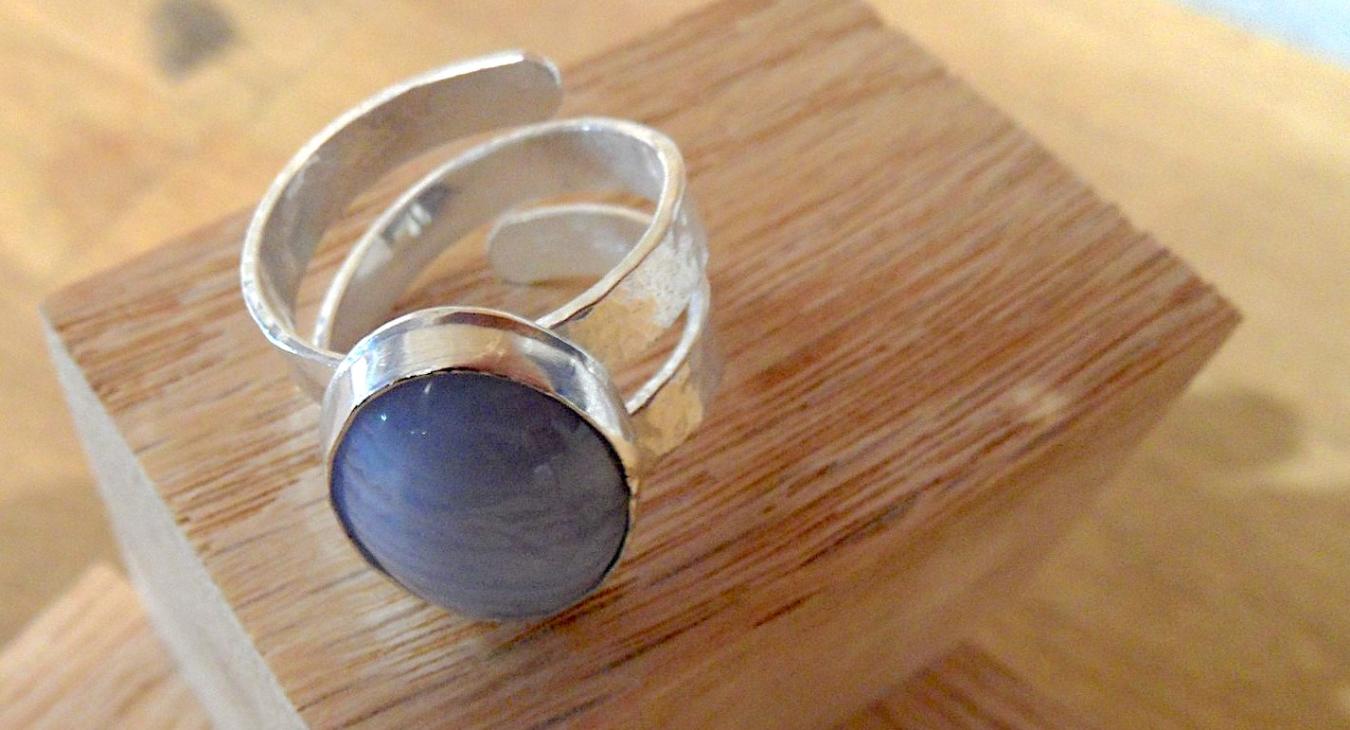 Silver ring with blue stone and swirl band