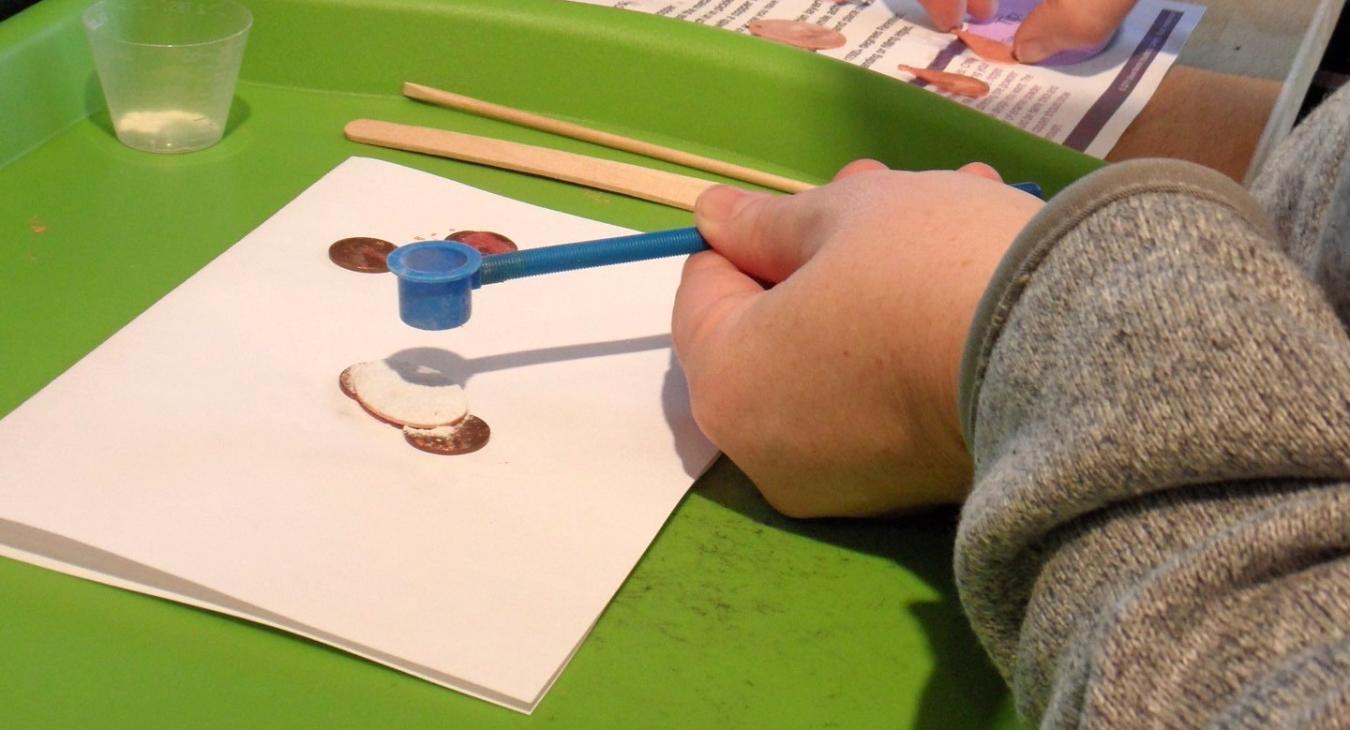 student sifting enamel onto piece