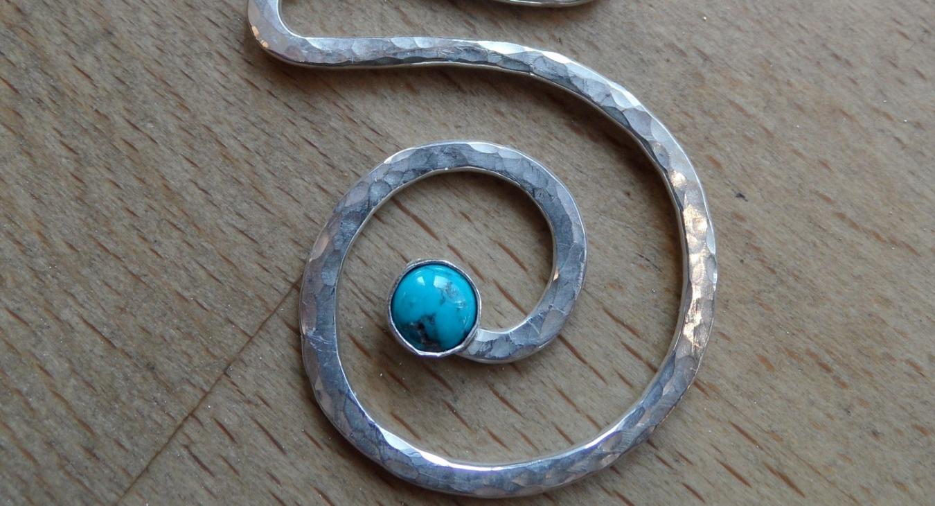 Hammered silver wire swirl pendant with turquoise stone by Sandi