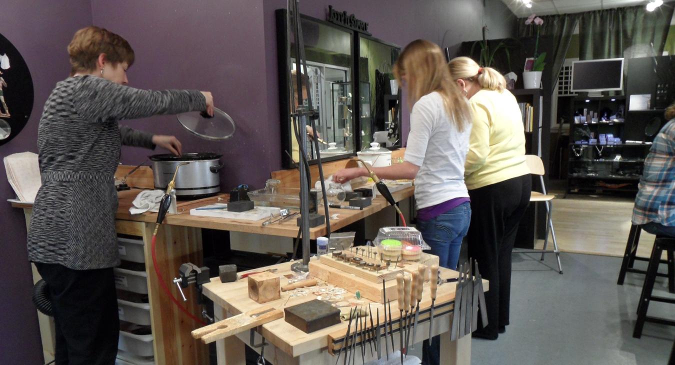 Students at solder stations working on charcoal casting