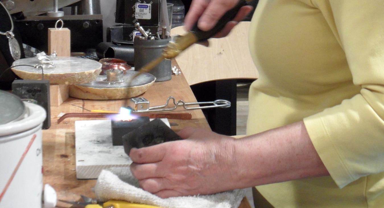 Getting ready to press the molten silver