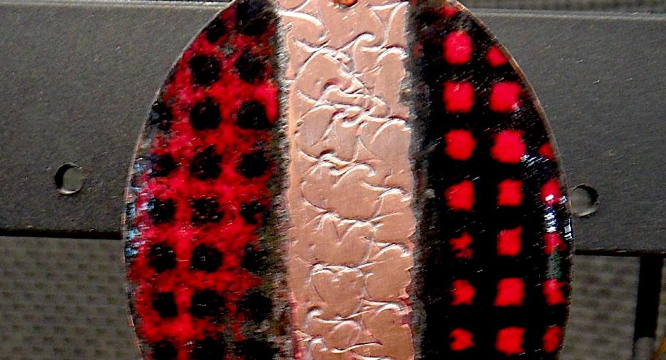 Enameled copper pendant with red and black checkered pattern