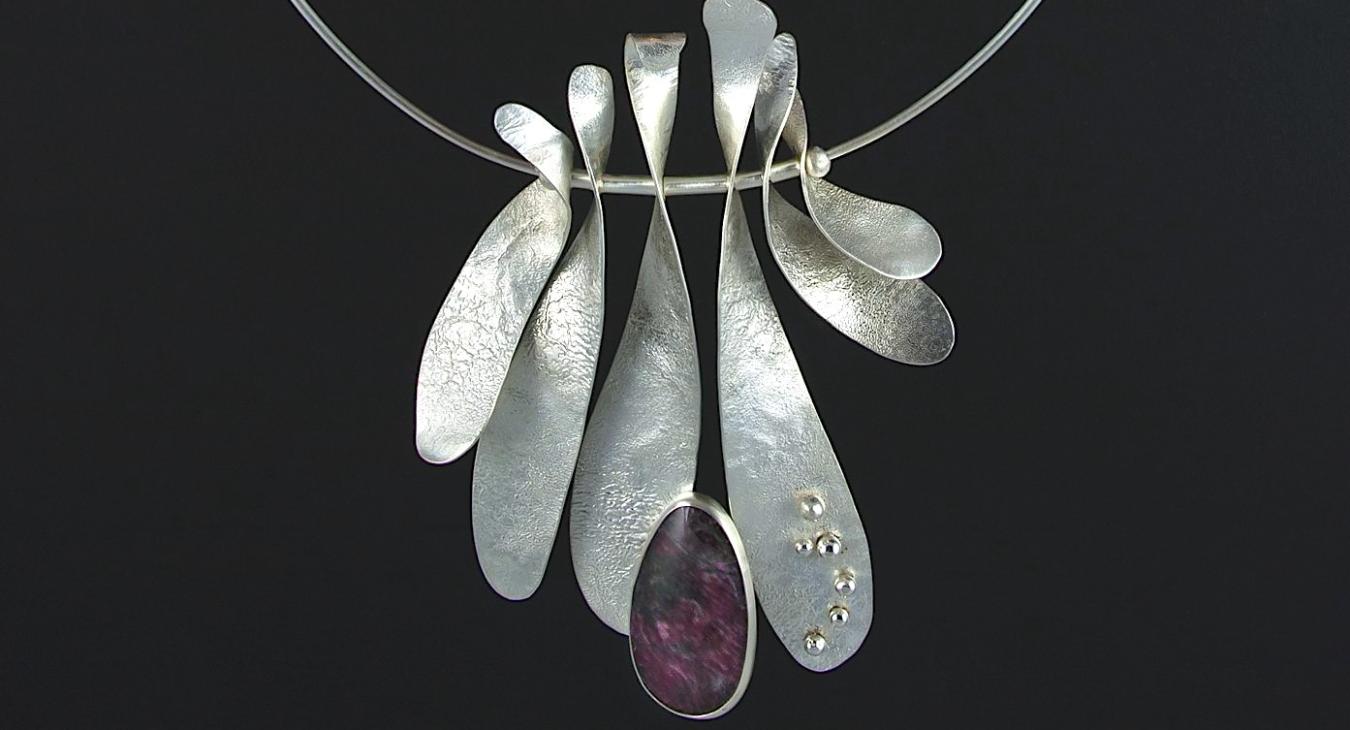 Finished silver pendant with six wave pieces and purple stone