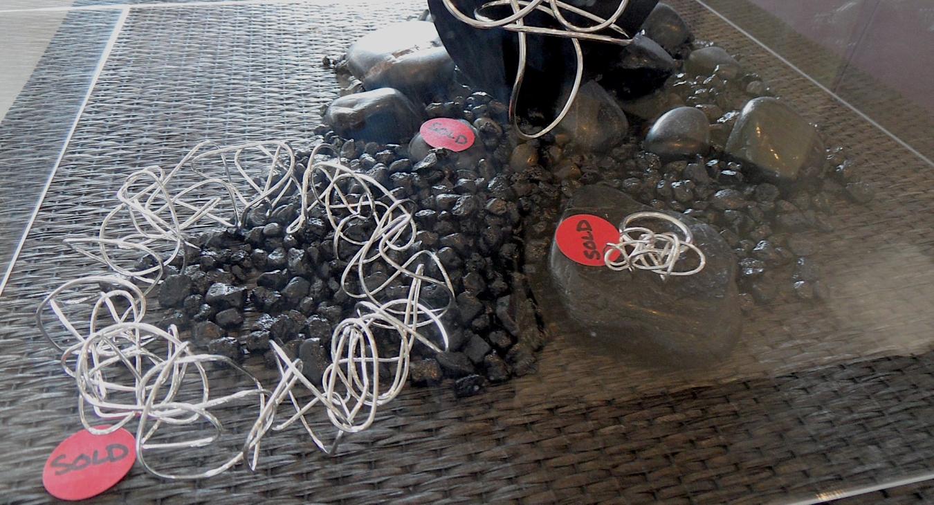 Pieces with red "sold" stickers
