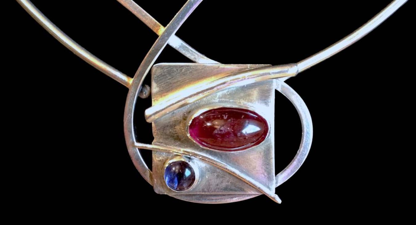 Red and blue stones set on silver wire and sheet pendant