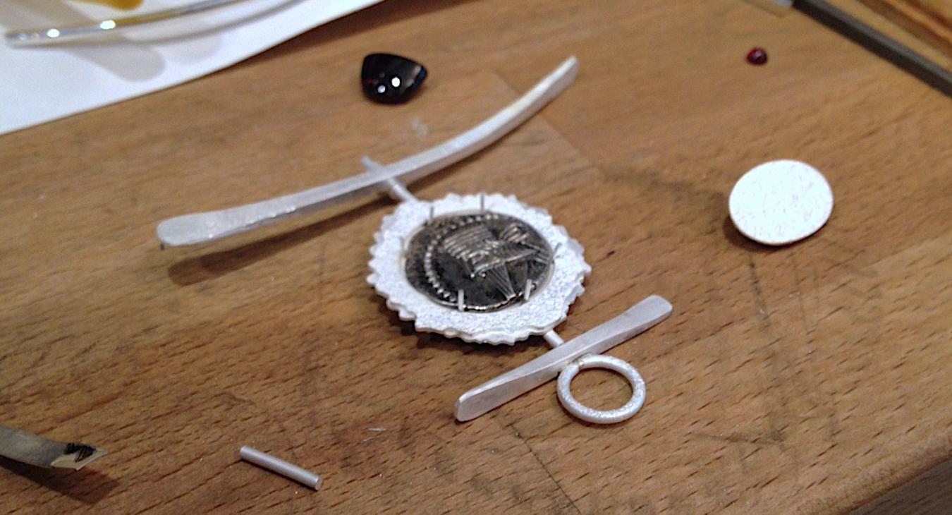 Testing the fit of the coin for the pendant