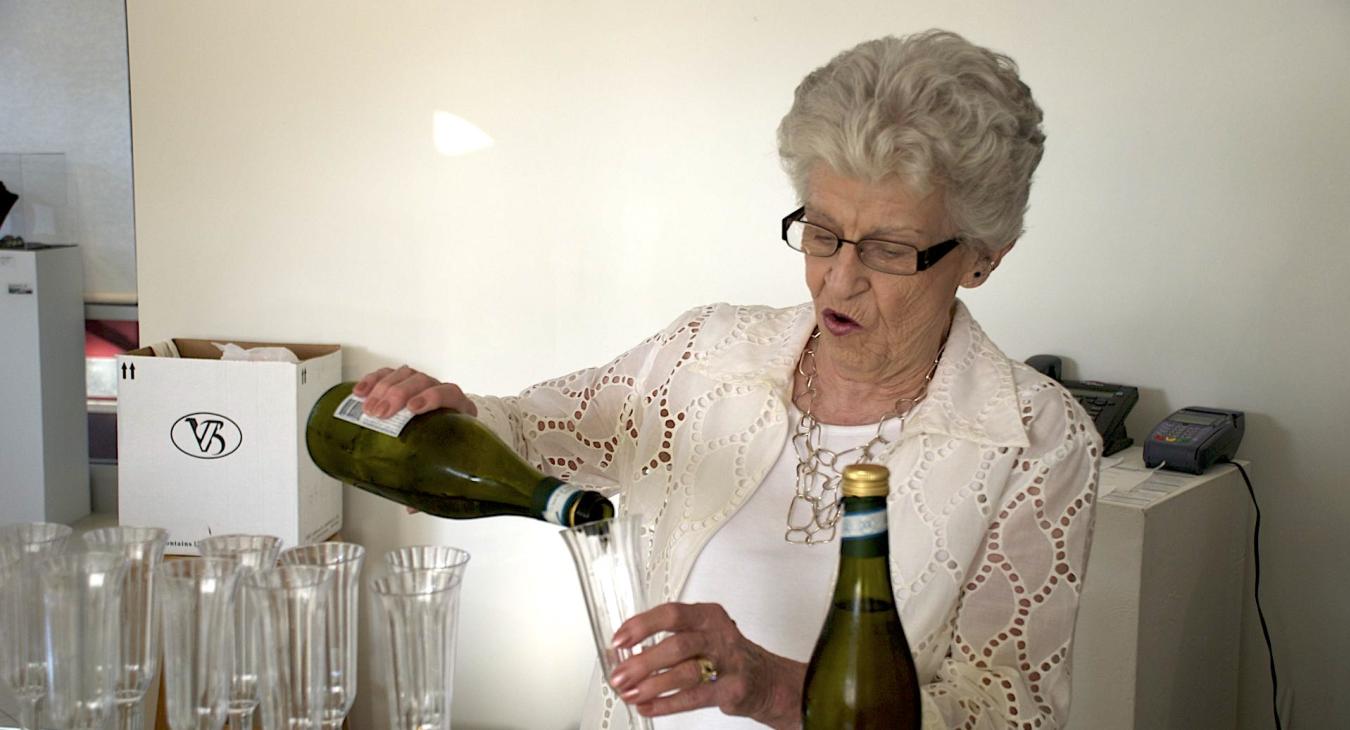 My mom Jan Callihan pouring champagne