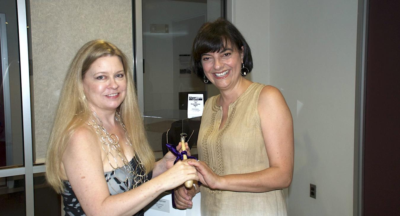 Elaine Speiser being presented with purple hammer award by Blair