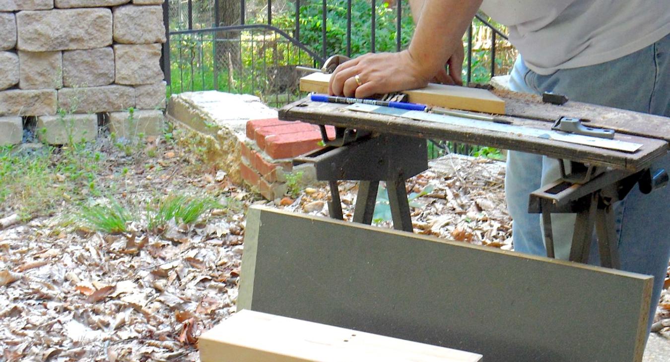Bryan sawing out support planks for forming stakes