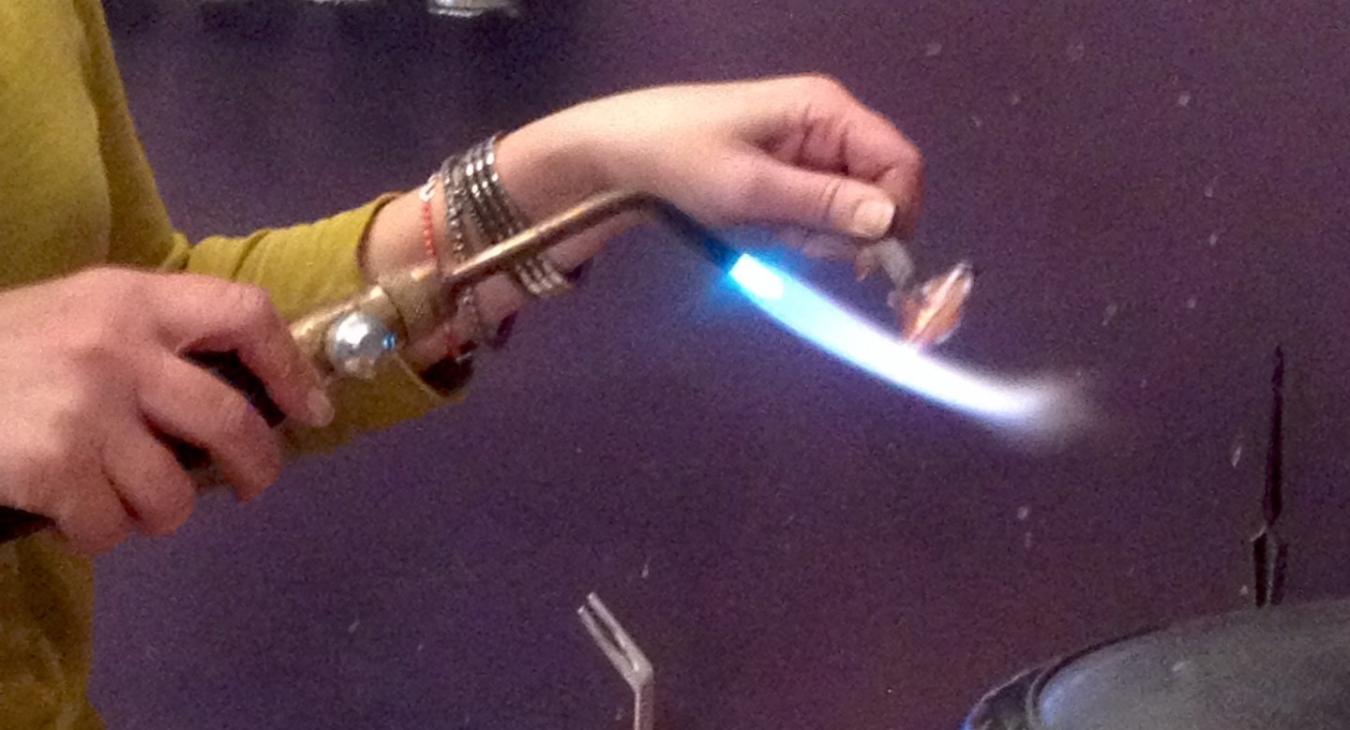 Here is a student adding a patina to the copper with the torch.
