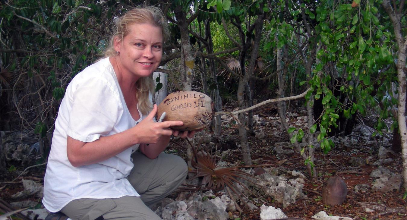 Blair planting a coconut