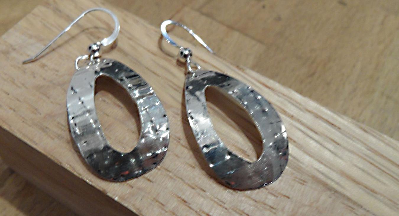 Textured silver oval earrings with oval opening