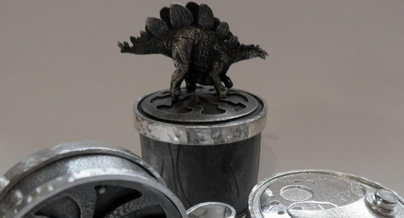 Silver boxes with cast dinosaur and other textures/layers 