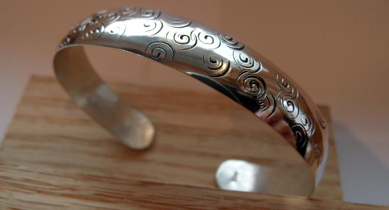 Silver bracelet with stamped swirls