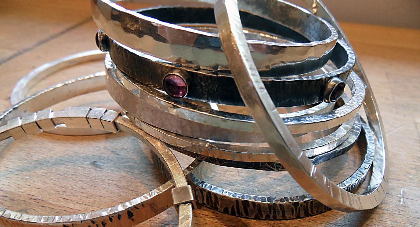 Silver bangles stacked up