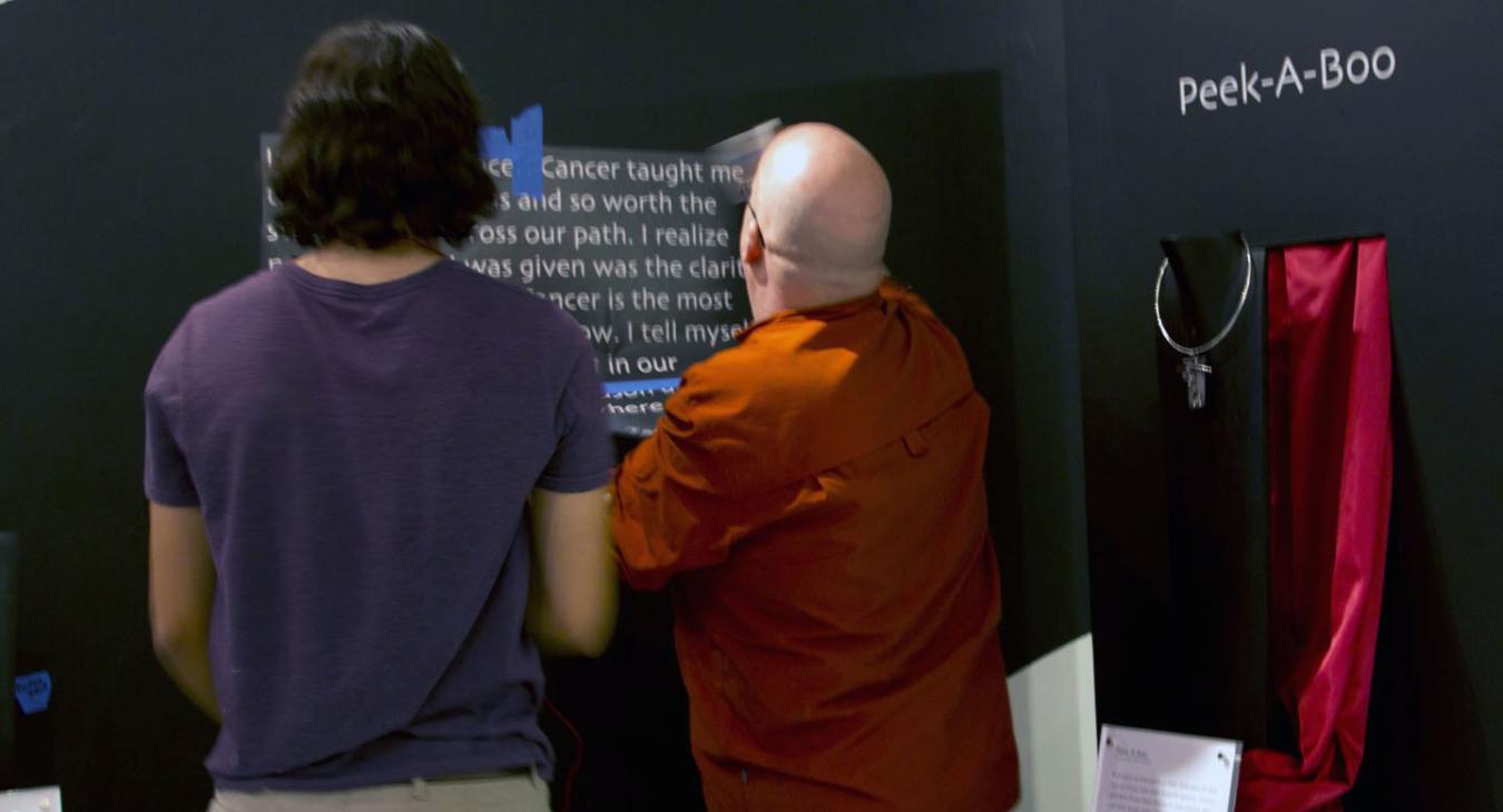 David and Bryan installing vinyl text on the wall