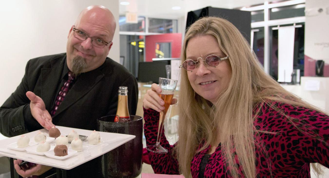 Bryan and Blair displaying the champagne and confections