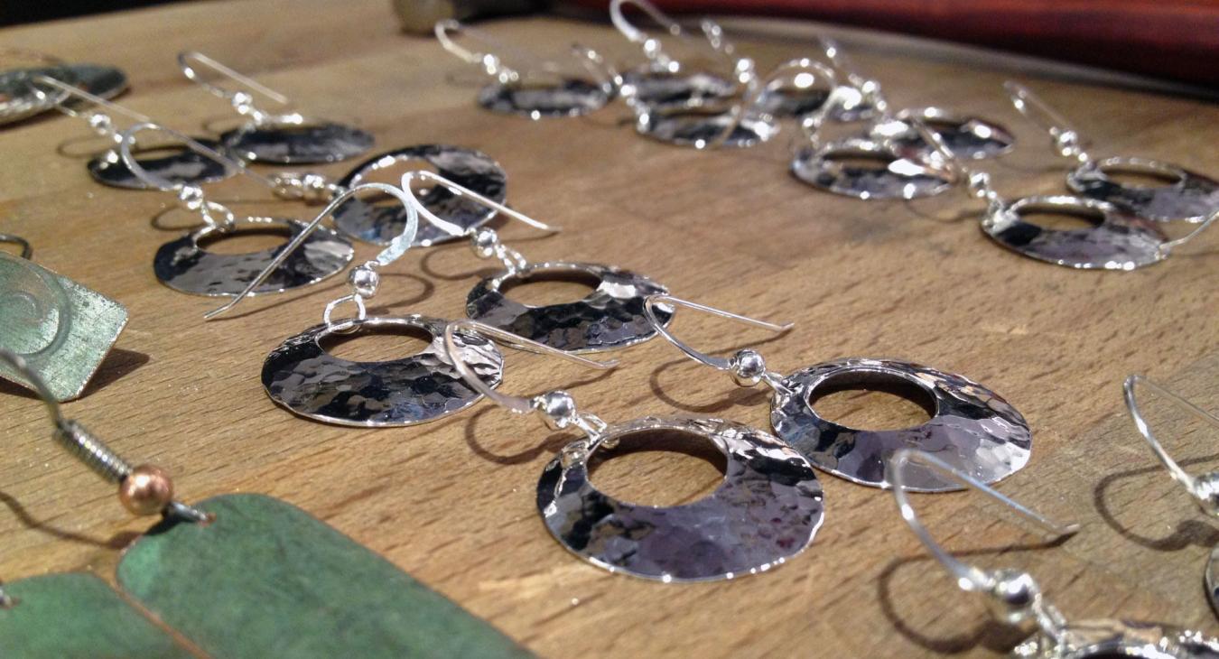 Hammered silver disc earrings and rooftop copper earrings in process