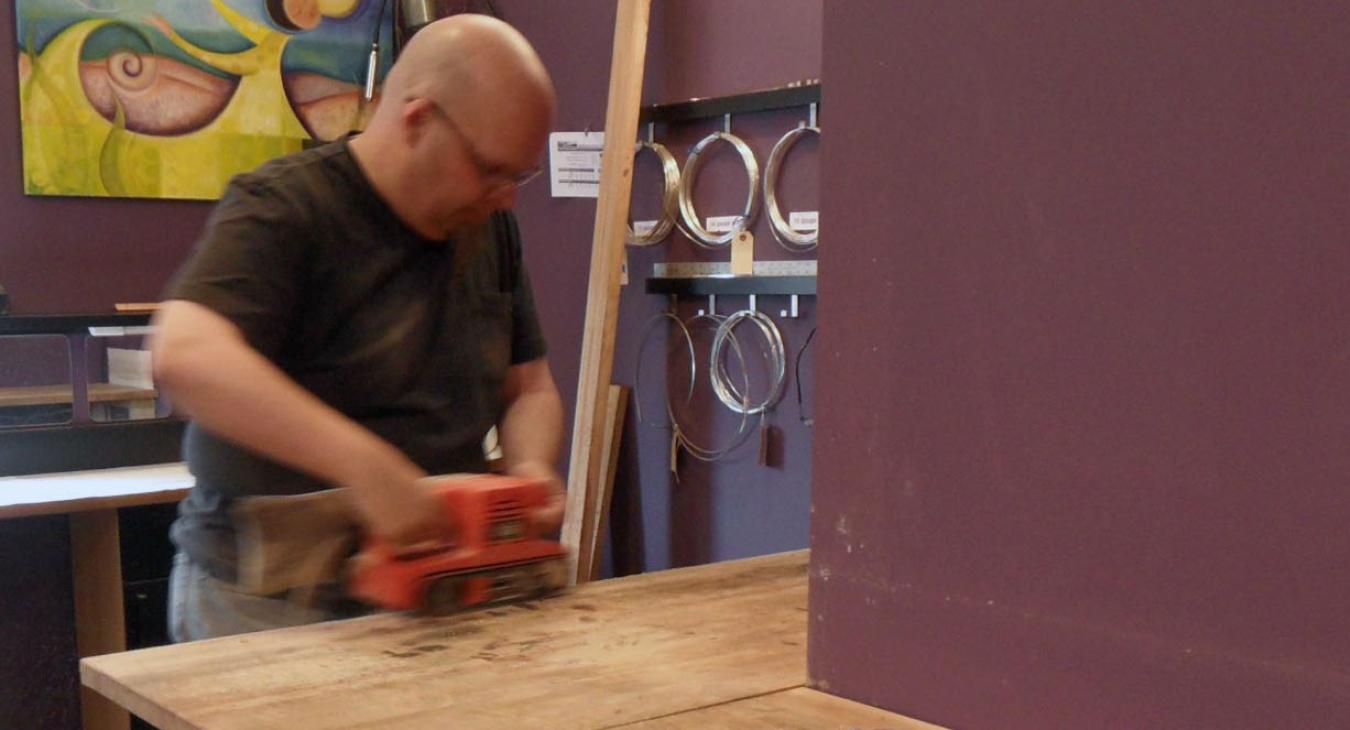 Bryan sanding down benches