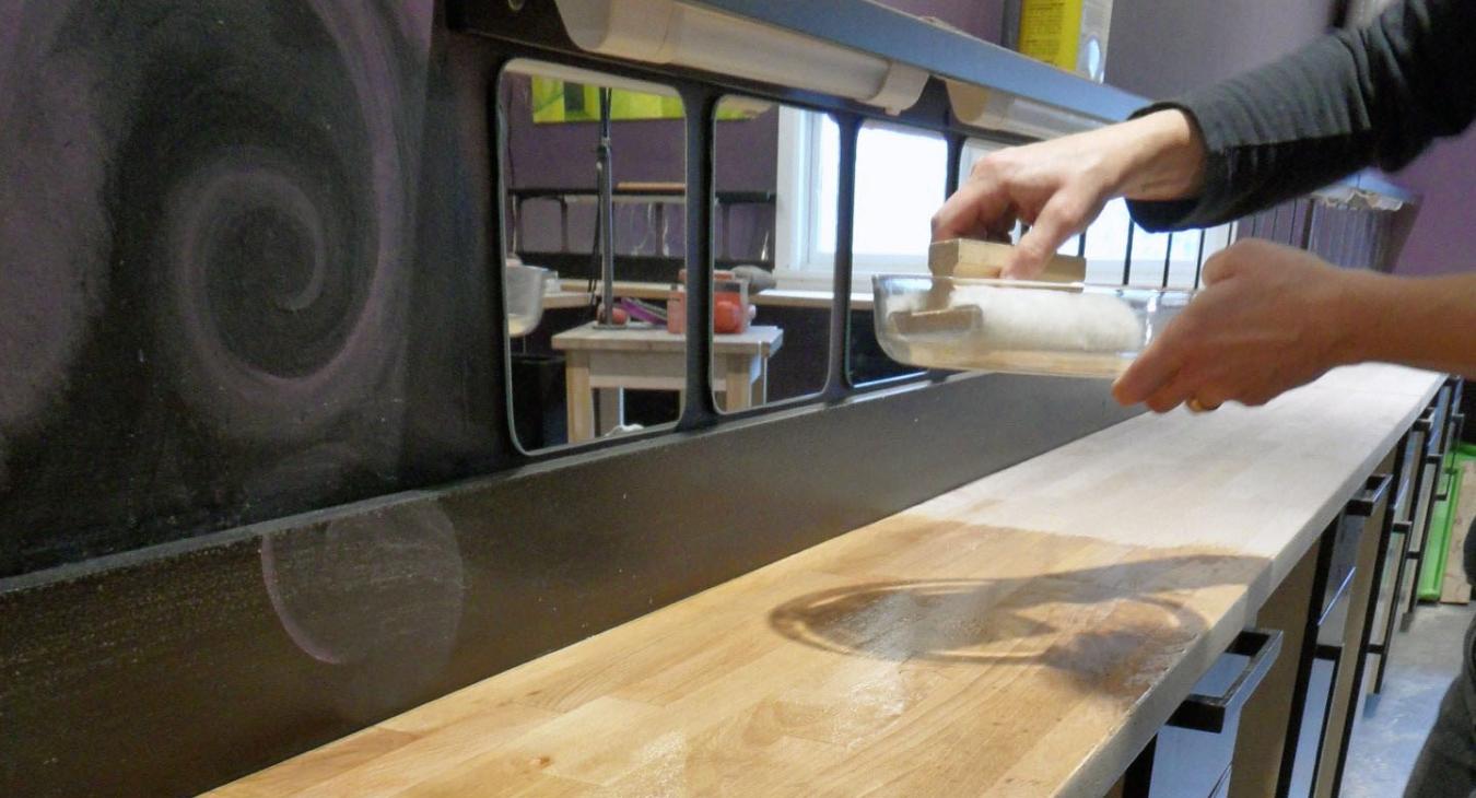 Helena oiling the newly-sanded benches