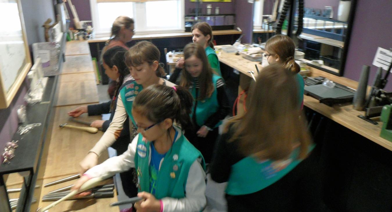 girl scouts gathered picking hammers