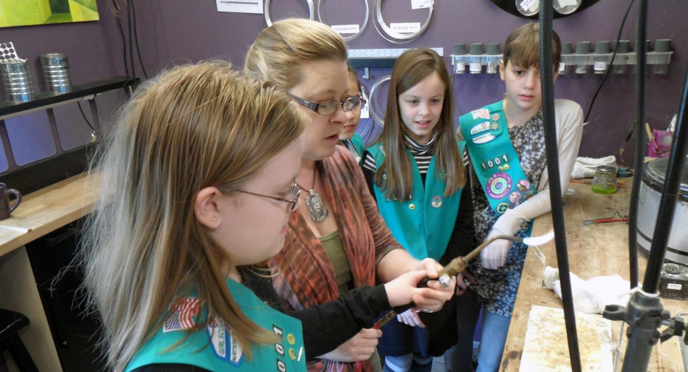 Blair demonstrating torch use to girl scouts