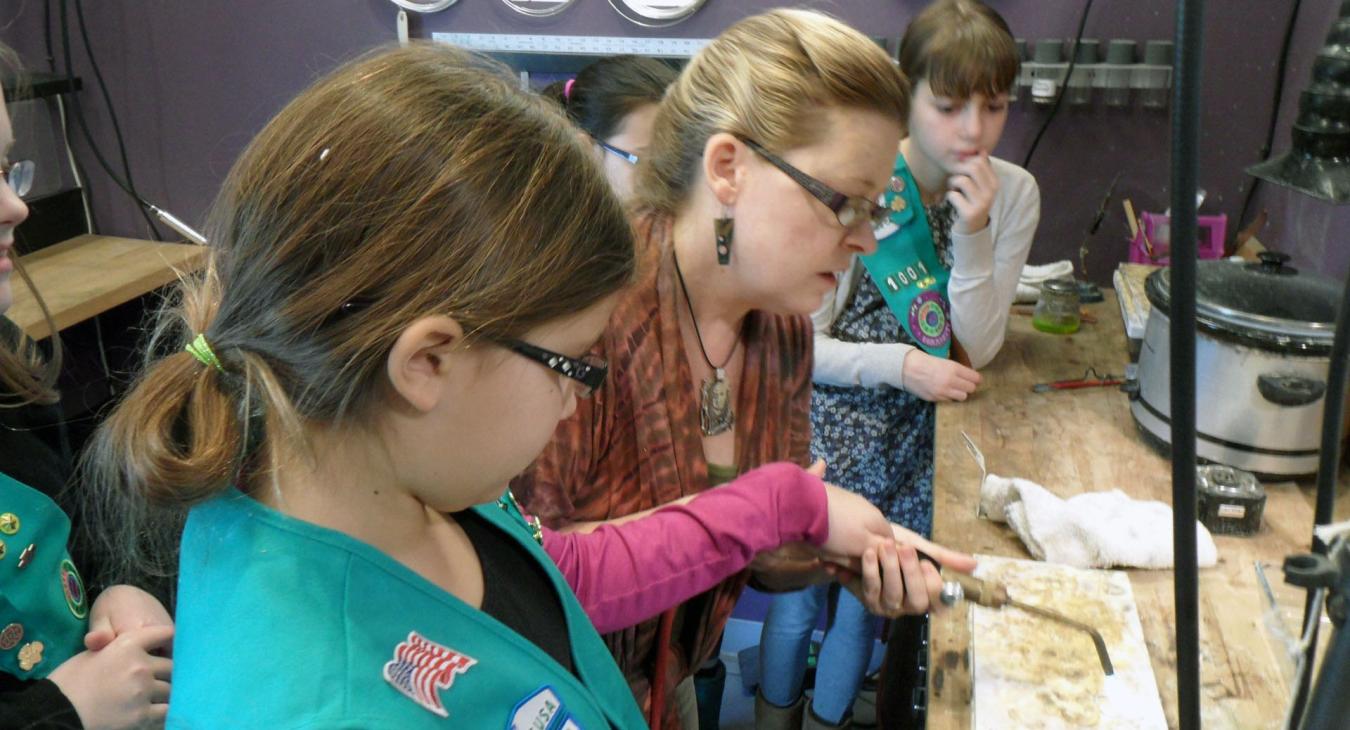 Blair demonstrating torch use to girl scouts