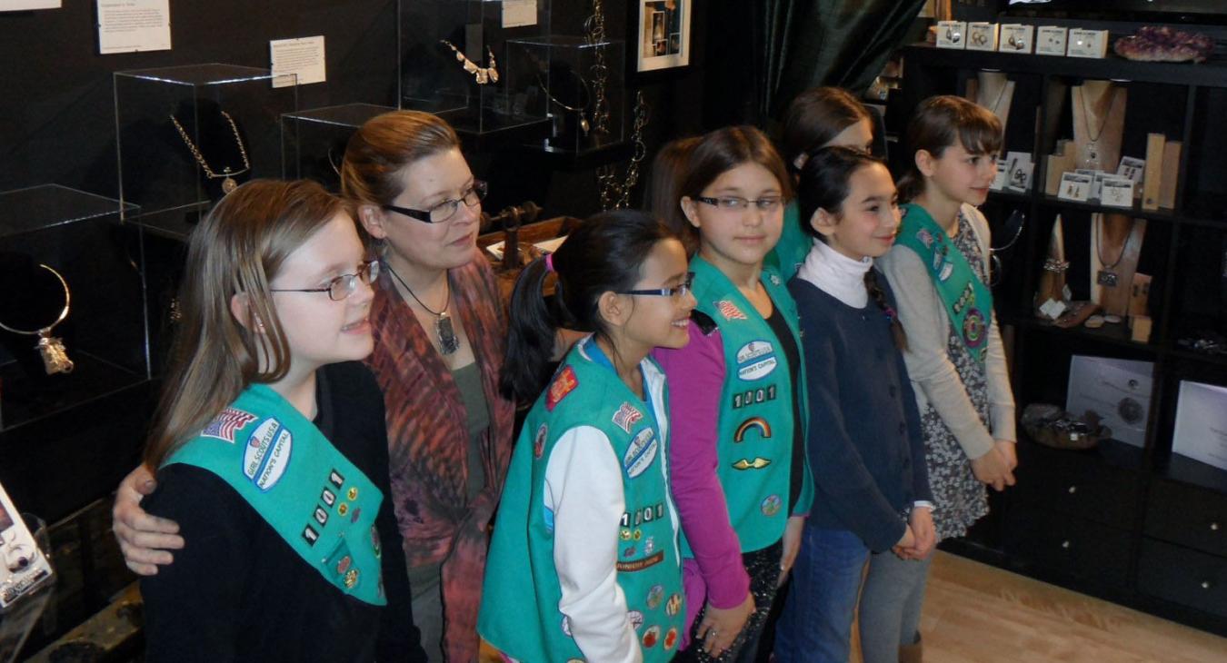 Blair and scouts standing in front of displayed work