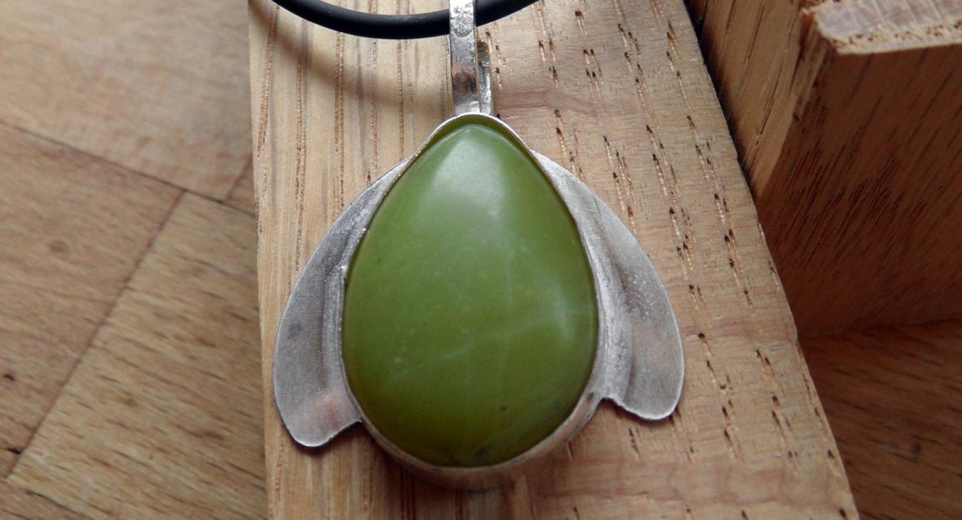 green stone set with silver wings pendant