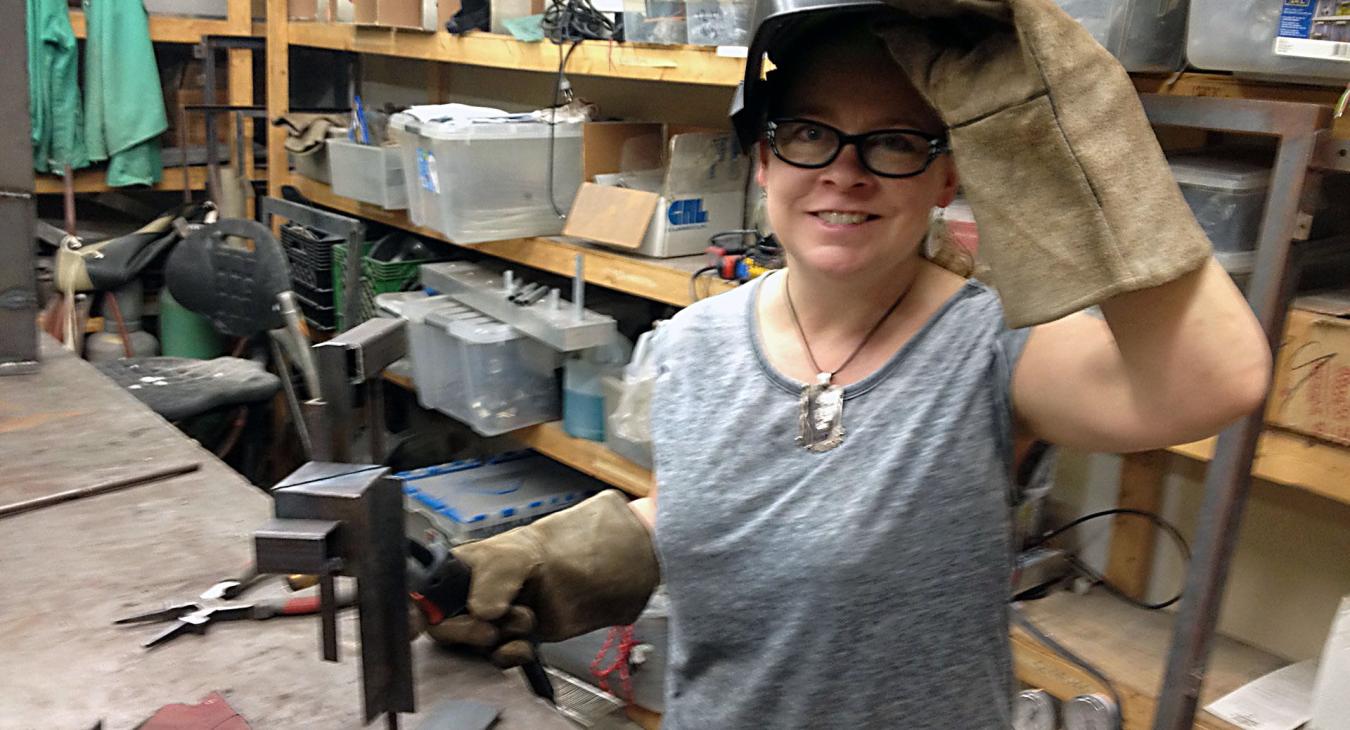 Blair holding welding visor and welder