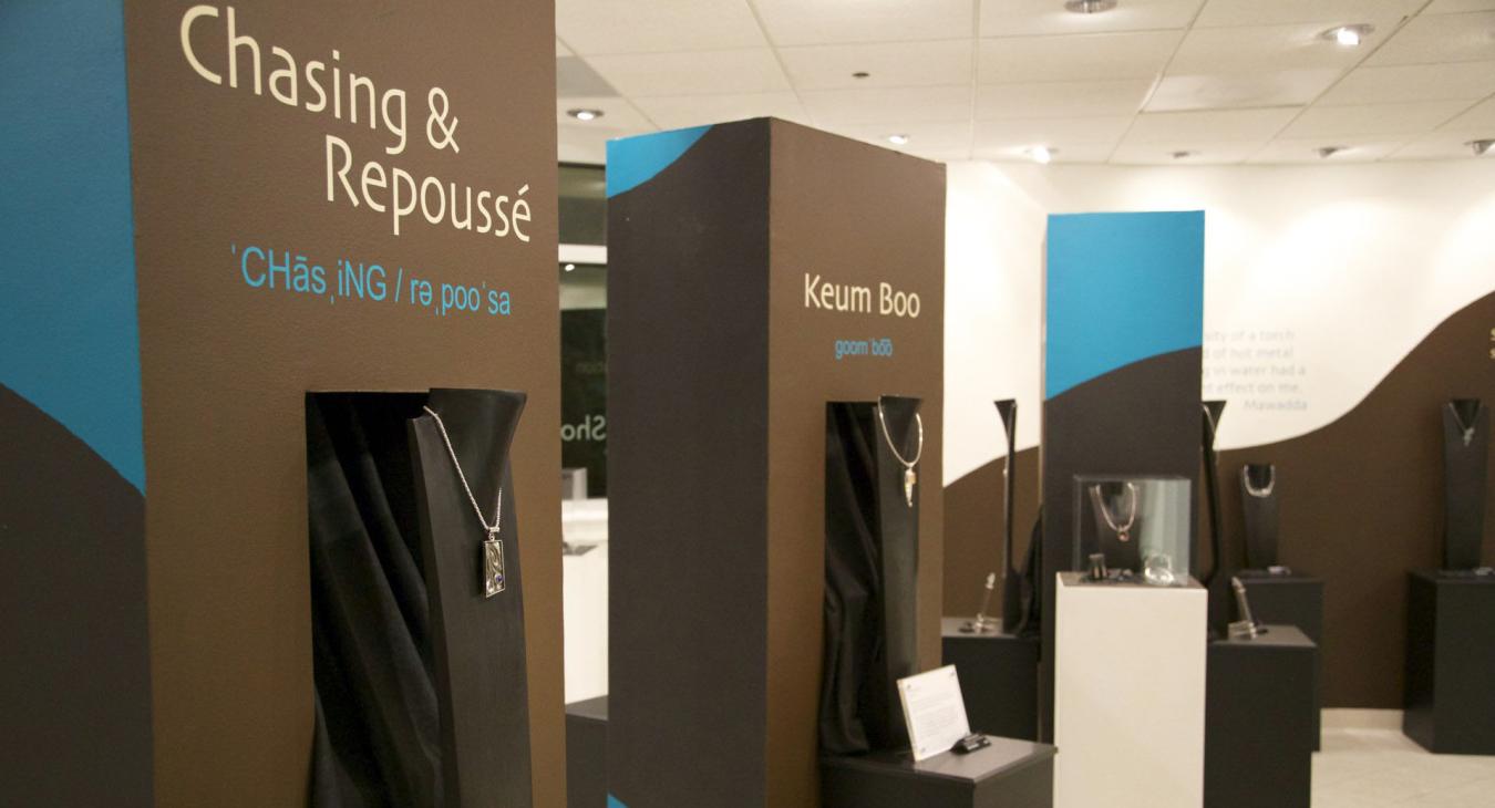 Display towers with chasing & repoussé and keum boo necklaces