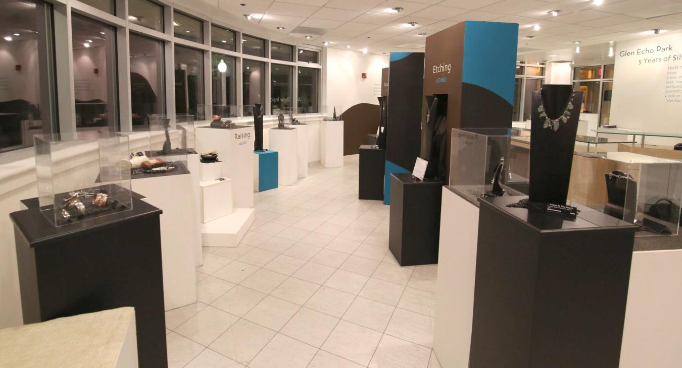 full shot of the gallery with towers and case displays next to windows
